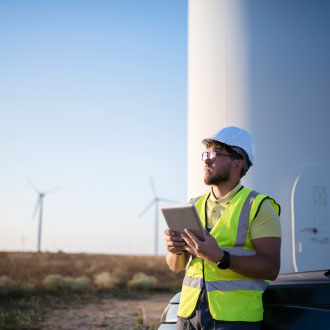 technician in wind energy field making observations