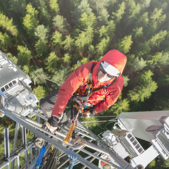 technician climbing cell tower